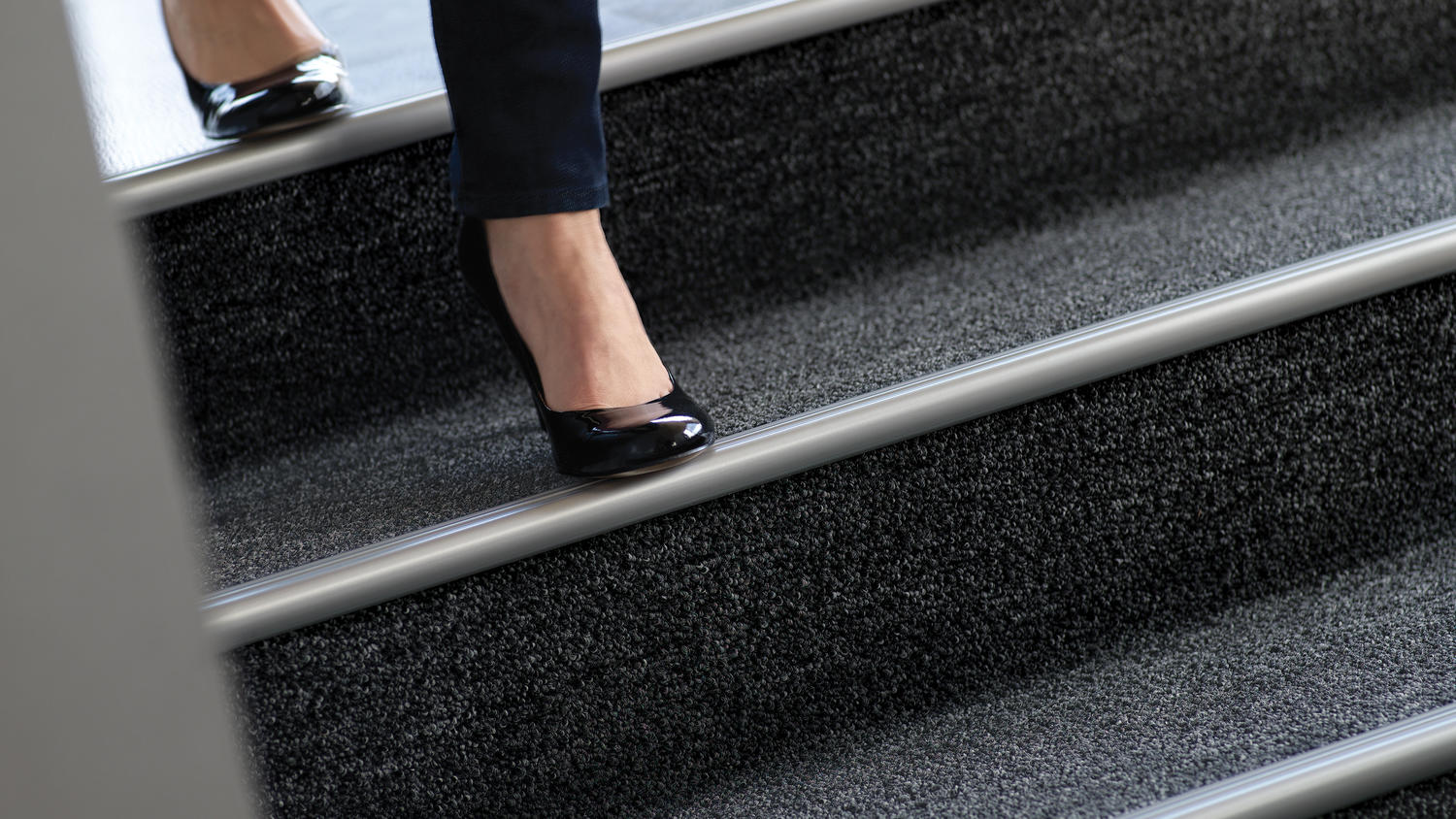 Woman walking down stairs | Markville Carpet & Flooring