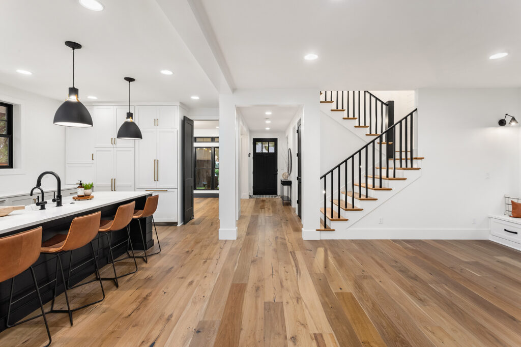 Kitchen and living room interior in new luxury home with open concept with hardwood floors by Markville in Toronto and Markham Ontario.