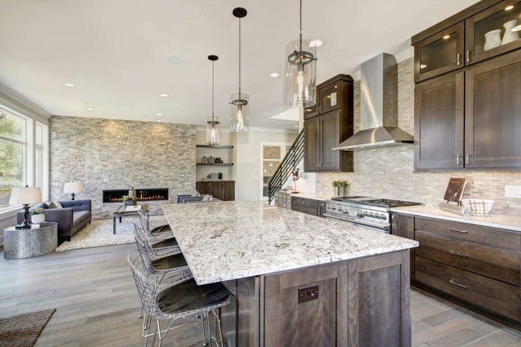 Luxury laminate flooring in a large kitchen with an island, leading to the living room by Markville in Markham, ON & Toronto, Ontario.