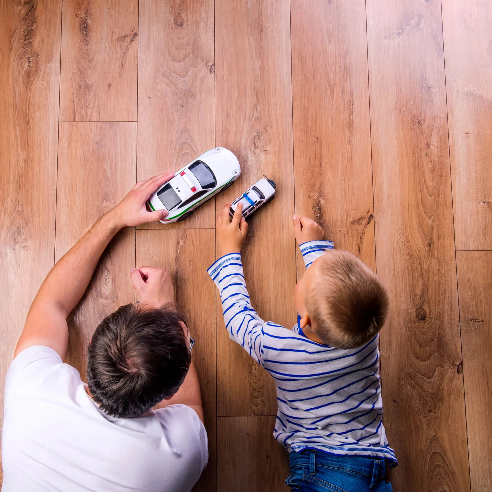 Dad son playing with toy car | Markville Flooring